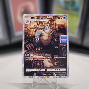 May include: A Blastoise Pokemon card from the Pokemon Trading Card Game. The card features a blue and brown Blastoise with a blue background. The card has a HP of 150 and an attack called Hydro Pump that does 80+ damage. The card also has a weakness to lightning and a retreat cost of 3.