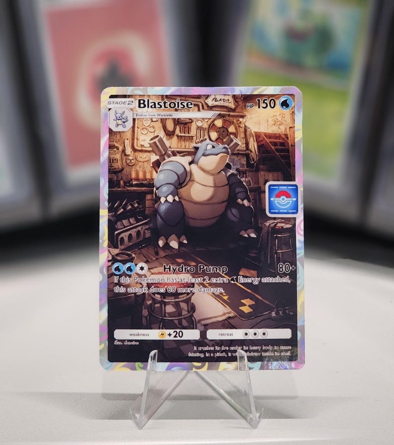 May include: A Blastoise Pokemon card from the Pokemon Trading Card Game. The card features a blue and brown Blastoise with a blue background. The card has a HP of 150 and an attack called Hydro Pump that does 80+ damage. The card also has a weakness to lightning and a retreat cost of 3.