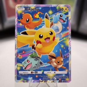 May include: A Pokemon trading card featuring Pikachu, a yellow electric mouse Pokemon, with other Pokemon including Bulbasaur, Charmander, and Squirtle. The card has a blue background with stars and rainbow streaks. The card text reads "BASIC Pikachu HP60 4 Gnaw 20 weakness +20 retreat When this Pokemon is knocked out, discard the top card of your deck.  "
