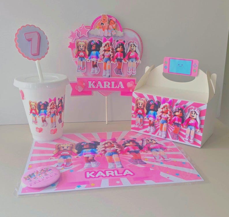 May include: A party set featuring a pink and white theme with cartoon character illustrations. Includes a cup, cake topper, gift box, placemat, and a pin. The name "KARLA" is printed on the placemat and cake topper.