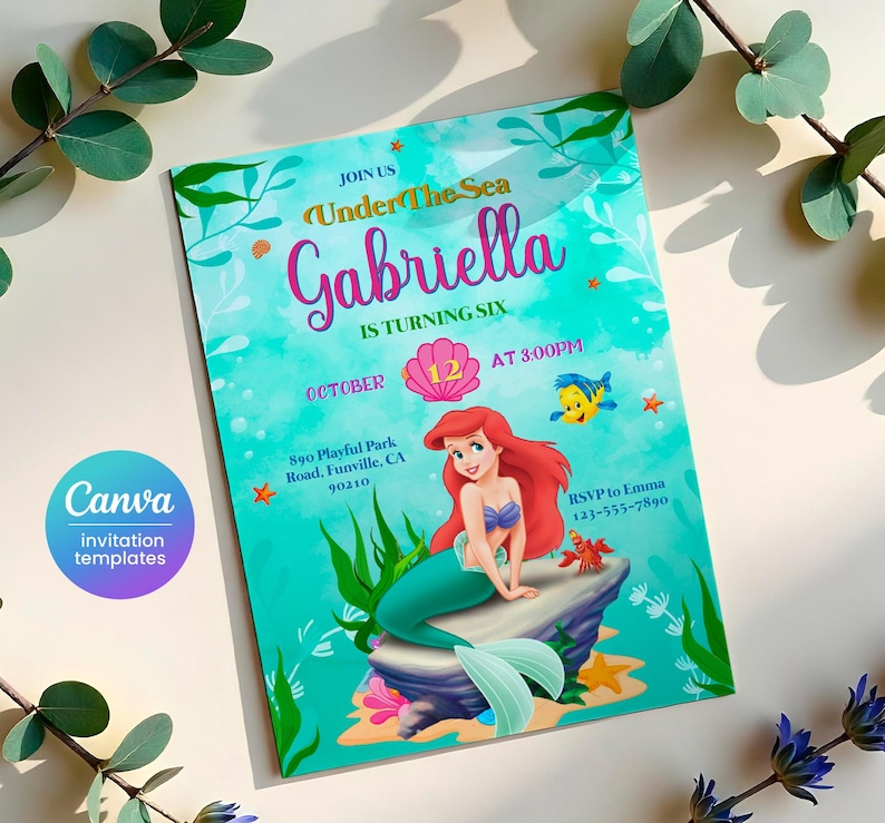 May include: A teal blue invitation with a watercolor effect. The invitation features a mermaid with red hair and a pink seashell. The text reads "Join us Under The Sea Gabriella is turning six October 12 at 3:00 PM 890 Playful Park Road, Funville, CA 90210 RSVP to Emma 123-555-7890".