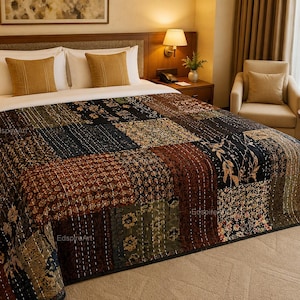 May include: A patchwork quilt featuring a variety of dark-toned fabric squares with intricate floral and geometric patterns in shades of brown, black, and green, accented by visible white running stitch quilting throughout the entire surface.