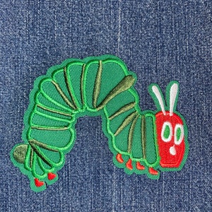 May include: Green and red embroidered iron-on patch of a caterpillar with white antennae and two large eyes.