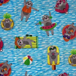 May include: A repeating pattern of cartoon sloths enjoying summer activities on a blue water background. Sloths are depicted with sunglasses, on floats, and as popsicles. Other elements include a beach ball and a green and yellow lounge chair.