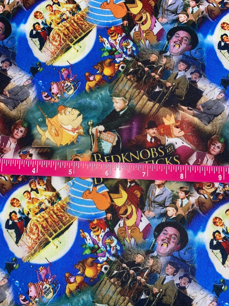 May include: A colorful fabric featuring a collage of movie scenes, including "The Briney Boys", "Bedknobs and Broomsticks", and "The Sound of Music". The fabric is a mix of blue, red, yellow, green, and white.