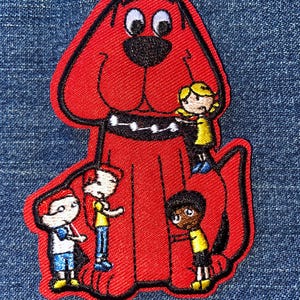 May include: Embroidered patch featuring a large red dog with black outlines and a black collar, surrounded by four children. The patch is on a blue denim background. The dog has a smiling expression.