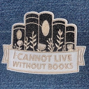 May include: Embroidered patch featuring a stack of books in black and beige, with floral accents. A banner below reads "I CANNOT LIVE WITHOUT BOOKS" in white lettering. The patch is set against a denim background.