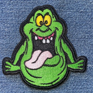 May include: A white ceramic mug with a black handle and the text "But First, Coffee" in a bold, black font. The mug sits on a white surface, showcasing its clean design.