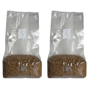 May include: Two clear plastic bags filled with brown grains. The bags have a small white square label on the front.