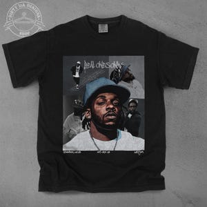 May include: Black t-shirt with a collage of images featuring Kendrick Lamar, the words "Real Ones Only", and the phrase "Not Lose Us".