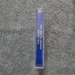 May include: A blue cassette tape with the text "ALC Records" in white, "Mike, Wiki, The Alchemist" in yellow, and "Faith Is A Rock" in yellow. The cassette tape also has the text "ALC-5051" in white.