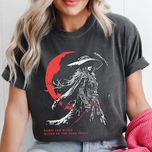 Woman wearing Comfort Colors Elden Ring t-shirt featuring Ranni the Witch Queen of the Dark Moon, anime Soulslike graphic tee for gamers