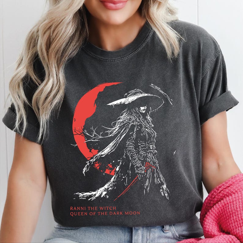 Woman wearing Comfort Colors Elden Ring t-shirt featuring Ranni the Witch Queen of the Dark Moon, anime Soulslike graphic tee for gamers