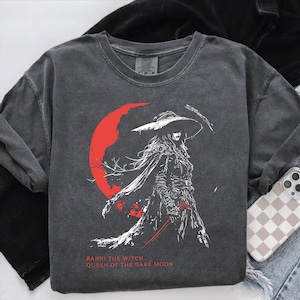 Folded Comfort Colors Elden Ring Ranni the Witch graphic shirt, Queen of the Dark Moon anime witch design, Soulslike gamer gift tee