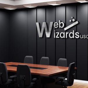 May include: A conference room with a large wooden table and black chairs. The wall features the text "Web Wizards usa" in silver lettering. The room has a modern design with dark walls and recessed lighting.