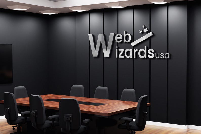 May include: A conference room with a large wooden table and black chairs. The wall features the text "Web Wizards usa" in silver lettering. The room has a modern design with dark walls and recessed lighting.