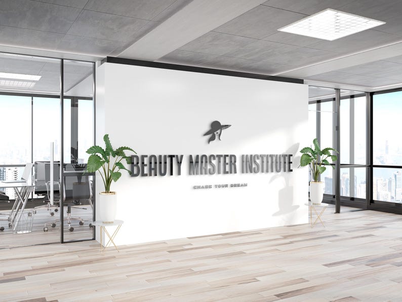 May include: Interior shot of a modern office space with the words "BEAUTY MASTER INSTITUTE" in metallic lettering on a white wall. A logo of a woman in a hat is above the text. The phrase "CHASE YOUR DREAM" is below the text.
