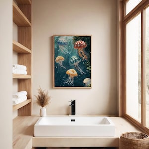 May include: A rectangular wall art print in a light wood frame featuring a deep blue underwater scene with six jellyfish in various colours including red, orange, yellow, and green, each with long trailing tentacles and white spots on their bells.