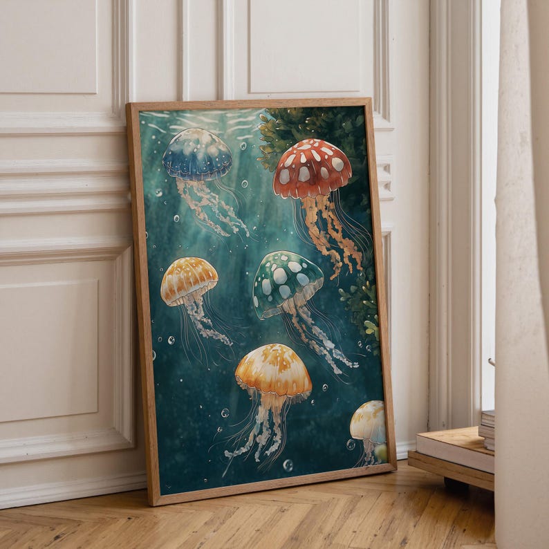 May include: A rectangular framed wall art print featuring a deep teal underwater scene with six jellyfish in various colours including red, orange, blue, and green. Each jellyfish has a translucent bell with white spots and long, flowing tentacles.