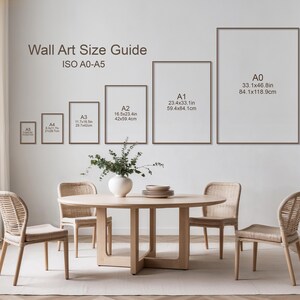May include: A room with a dining table, chairs, and framed wall art. The wall art size guide shows ISO A0-A5 sizes, with measurements in inches and centimeters. A vase with greenery sits on the table.