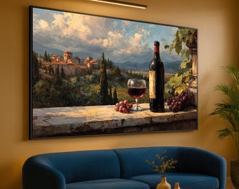 May include: A framed landscape painting depicts a Tuscan villa scene with a wine bottle, a glass of red wine, and grapes on a stone ledge. The painting is mounted above a blue sofa, with a small table and decorative vases.
