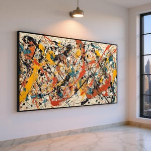 May include: Large framed abstract artwork. The painting has a beige background with splashes of yellow, orange, teal, and black paint. The black frame contrasts with the white wall it hangs on.