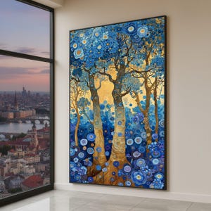 May include: A framed art print depicting a stylized forest scene. The artwork features tall trees with textured bark and branches, adorned with blue floral accents. The background has a golden hue, and the overall color palette includes shades of blue, gold, and brown.