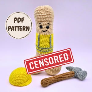 May include: A beige crochet phallic figure wearing a yellow vest with gray trim, featuring black safety eyes and a stitched smile. Beside it sits a yellow crochet hard hat and a gray and brown crochet hammer. Text reads PDF PATTERN and CENSORED.