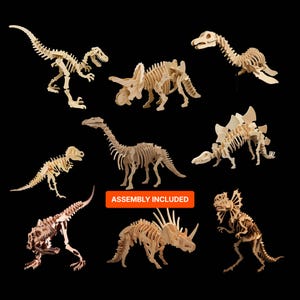 May include: A collection of wooden dinosaur skeleton models, including a Tyrannosaurus Rex, Triceratops, and Stegosaurus, against a black background. The models are light brown and appear to be unassembled. The text "ASSEMBLY INCLUDED" is visible.