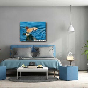 May include: A canvas print of a duck with outstretched wings in blue water. The duck has brown, orange, and white feathers. The canvas is 30 x 40 inches (76 x 102 cm).