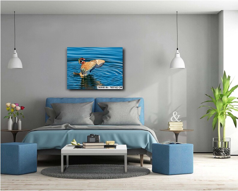 May include: A canvas print of a duck with outstretched wings in blue water. The duck has brown, orange, and white feathers. The canvas is 30 x 40 inches (76 x 102 cm).