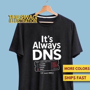 May include: A black short-sleeve t-shirt featuring the white text It's Always DNS. Below the text is a graphic of a checklist labelled Root-Cause Analysis with a tick next to DNS and a red box stating Root Cause Found at 02:33 AM.