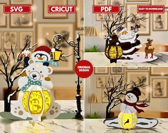 May include: A collection of Christmas-themed paper cutouts featuring a polar bear, penguin, Santa Claus, and snowman. Each cutout has a lantern with a warm glow. The designs include the text "SVG", "CRICUT", "PDF", and "EASY TO DOWNLOAD".