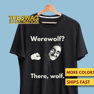 May include: Black t-shirt with a humorous werewolf design. The shirt features the text "Werewolf? There, wolf." and a cartoon illustration of a man pointing. The Swag Illustration logo is at the top.