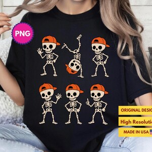May include: Black t-shirt featuring cartoon skeletons wearing orange baseball caps. The skeletons are in various poses, including waving, standing with hands on hips, and doing a handstand. The shirt has the text "ORIGINAL DESIGN", "HIGH RESOLUTION", and "MADE IN USA".