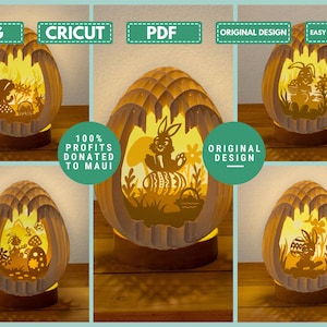 May include: A decorative Easter egg-shaped lamp with a layered design, featuring cut-out silhouettes of bunnies, flowers, and eggs. The lamp is illuminated from within, creating a warm glow. Text on the image includes "SVG", "CRICUT", "PDF", "ORIGINAL DESIGN", "EASY TO DOWNLOAD", and "100% PROFITS DONATED TO MAUI".