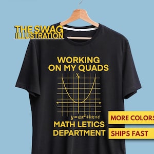 May include: Black t-shirt featuring a yellow parabola graphic and the words "WORKING ON MY QUADS" and "MATH LETICS DEPARTMENT". The shirt also has the text "MORE COLORS" and "SHIPS FAST".