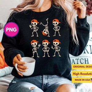 May include: Black sweatshirt featuring a skeleton graphic wearing orange caps. The skeletons are in various poses. The design includes the text "ORIGINAL DESIGN", "High Resolution", and "MADE IN USA".