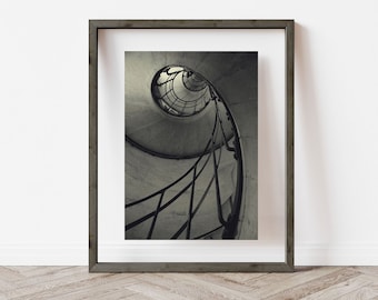 May include: A black and white photograph of a spiral staircase with a metal railing. The staircase is framed in a dark wood frame.