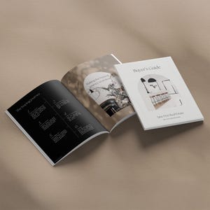 May include: An open book with a black cover and white text that reads "The Buying Journey". The right page features a photo of a modern interior with a plant and the text "Making the buying journey seamless". The cover of the closed book is white with black text that reads "Buyer's Guide" and "Jane Doe Real Estate".