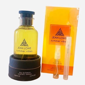 May include: A perfume set featuring a clear glass bottle with a dark blue cap and the text "JEAN LOWE summer vibes." The set includes a yellow box and two small spray bottles. The perfume bottle contains 100ml / 3.4 fl oz.