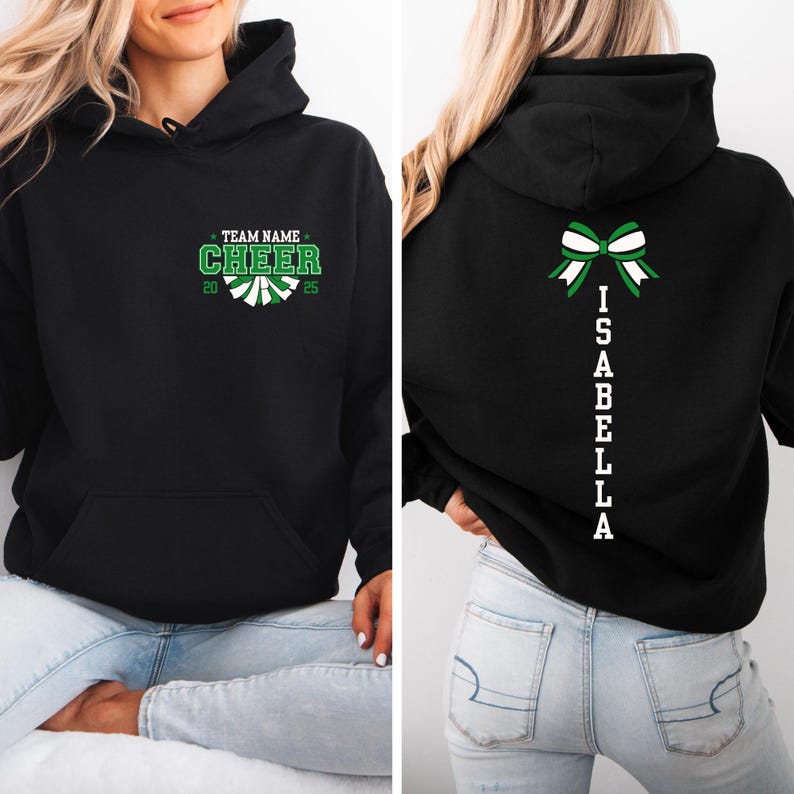 May include: Black hoodie with a green and white cheerleading design on the front and a white bow and the name "ISABELLA" on the back.