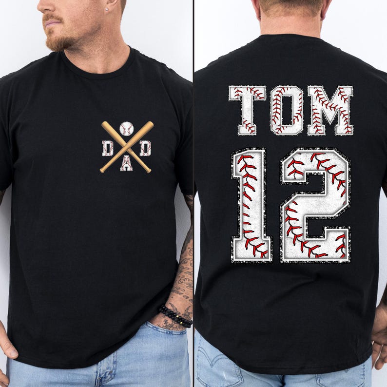 May include: Black t-shirt with a baseball-themed design. The front features crossed baseball bats, a baseball, and the word "DAD." The back displays "TOM 12" in a baseball stitch font.