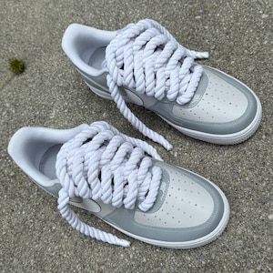 top view of white and grey air force ones patent leather with rope laces