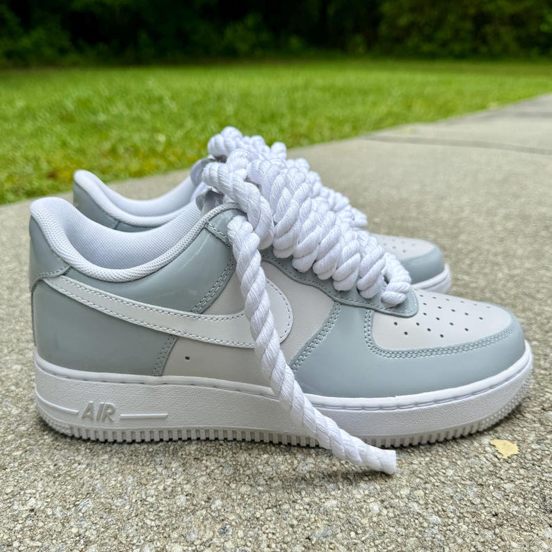 side view of white and grey patent leather air force 1 with chunky rope laces