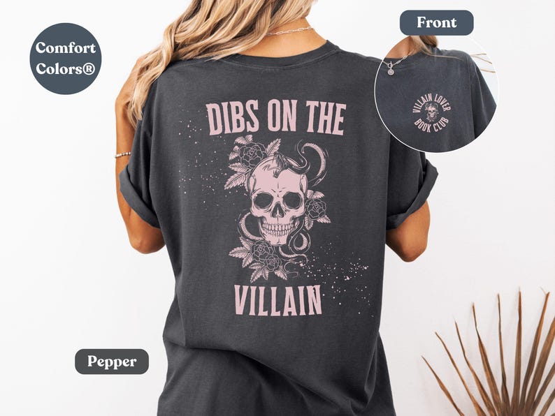 Lifestyle image of a villain lover Comfort Colors® t-shirt in pepper color. Text on the shirt says "dibs on the villain". It's perfect as a villain lover or dark romance gift.