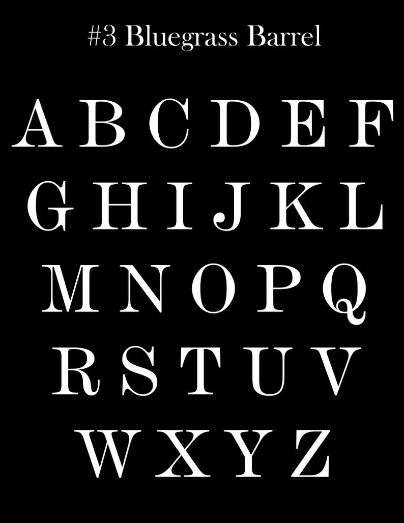 May include: A black background displays the alphabet in white serif font. The letters are arranged in rows, from A to Z. The text "#3 Bluegrass Barrel" is at the top. This image is suitable for educational materials or design projects.