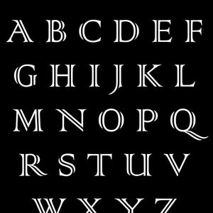 May include: A black background displays the alphabet in a white, elegant serif font. The text "#2 Kentucky Oak" is at the top. Each letter has a unique design, with some featuring double lines and decorative serifs.