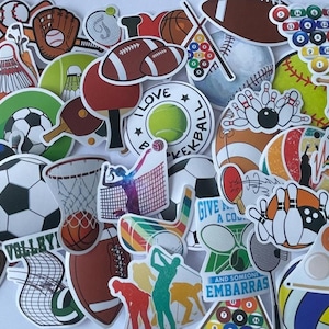 May include: A collection of colorful sports-themed stickers featuring various sports equipment. Includes footballs, basketballs, soccer balls, baseballs, bowling pins, tennis balls, and more. Some stickers have text like "I LOVE BASKETBALL" and "GIVE A CO".