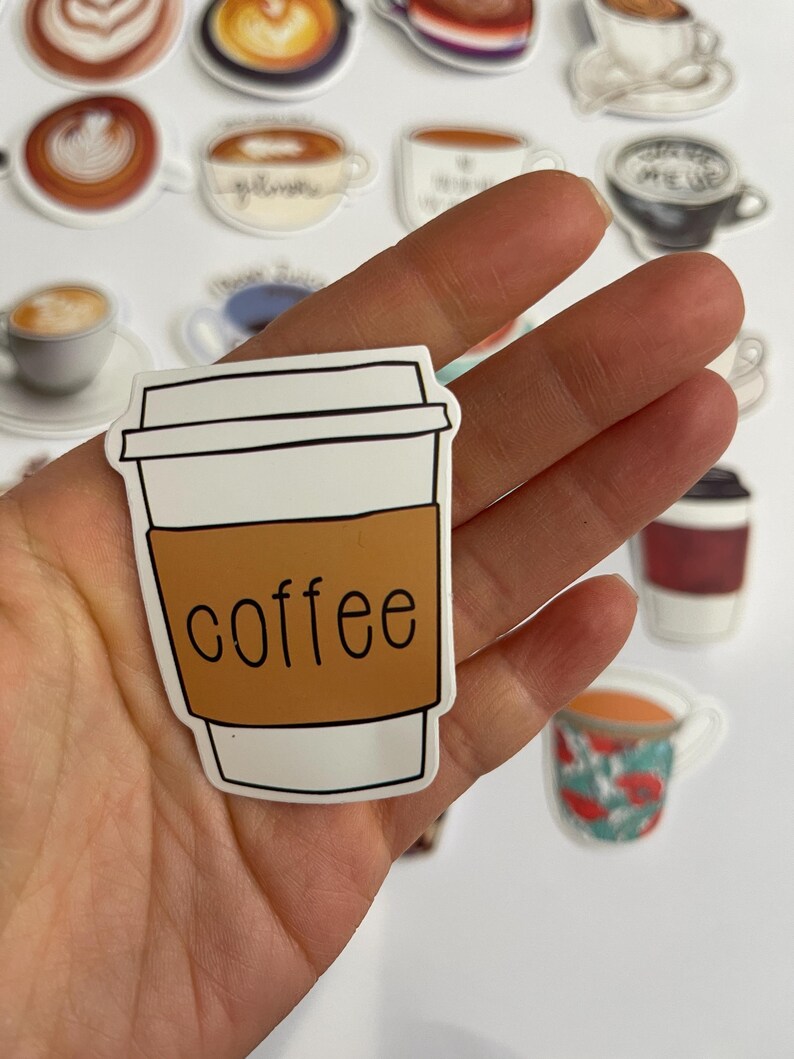 May include: A white to-go coffee cup with a brown lid and the word "coffee" printed on the side.